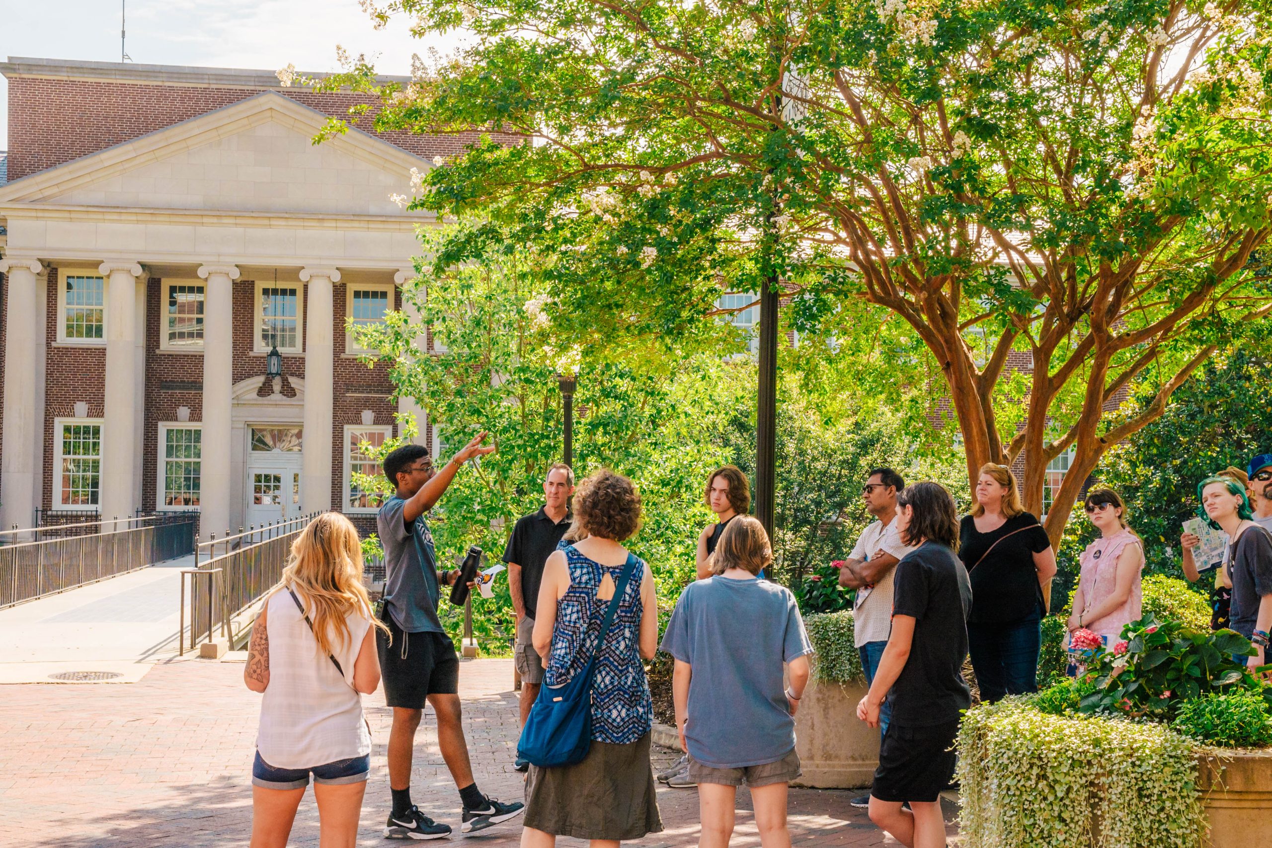 A group of students and their families on a campus tour.